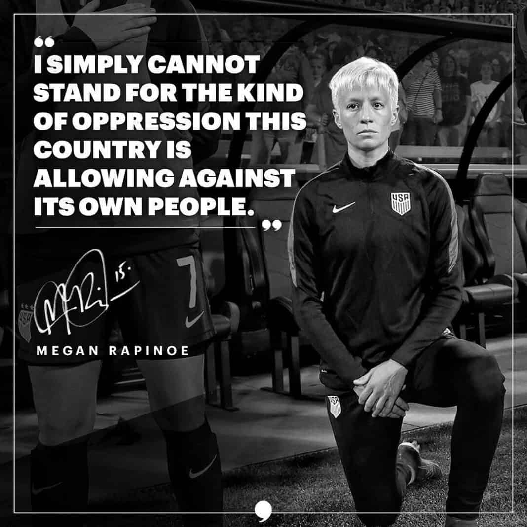Megan Rapinoe holding a microphone, addressing a crowd