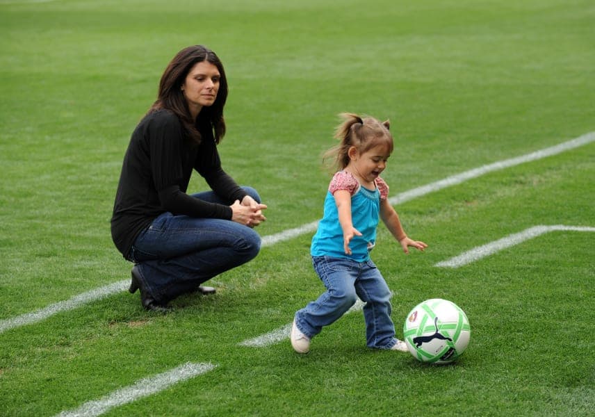 Mia Hamm and her child in the ground