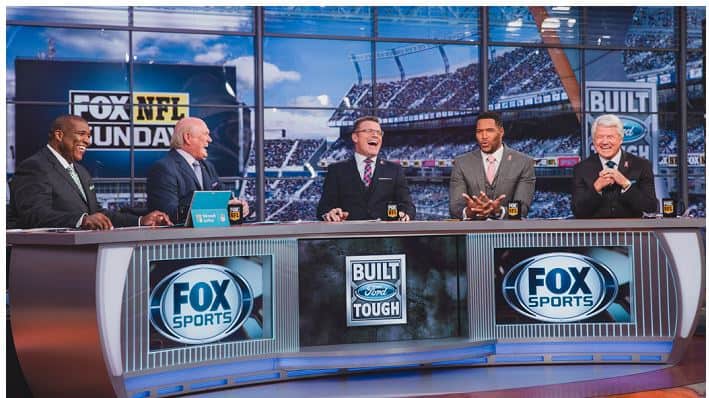 Howie Long, working as a studio analyst for NFL coverage by Fox Sports with his crew