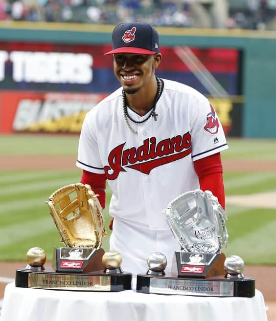 Francisco Lindor Showing His Platinum and Gold Glove Awards