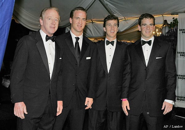 Eli Manning (far right) with his father Archie Manning (far left), Peyton Manning (second left), and Cooper Manning