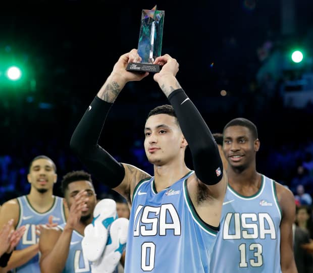 U.S. Team's Kyle Kuzma, of the Los Angeles Lakers holds the MVP trophy after the NBA All-Star Rising Stars basketball game between the World Team and the U.S. Team, Friday, Feb. 15, 2019, in Charlotte, N.C. The U.S. Team won 161-144. (AP Photo/Chuck Burton)