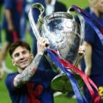 Lionel Messi smiles with 2014-15 UEFA Champions League trophy