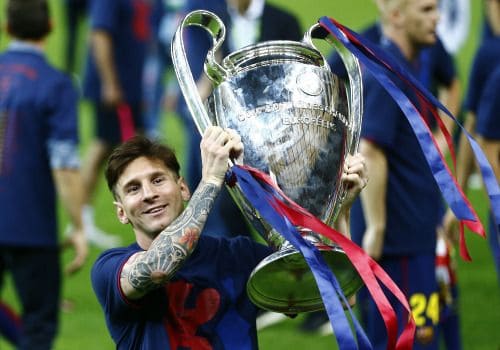 Lionel Messi smiles with 2014-15 UEFA Champions League trophy.