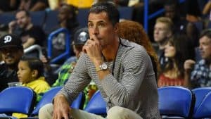 Rob Pelinka watches a NBA game from the seats.