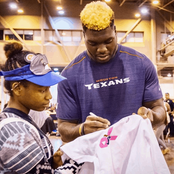 Signing an autograph to his fan