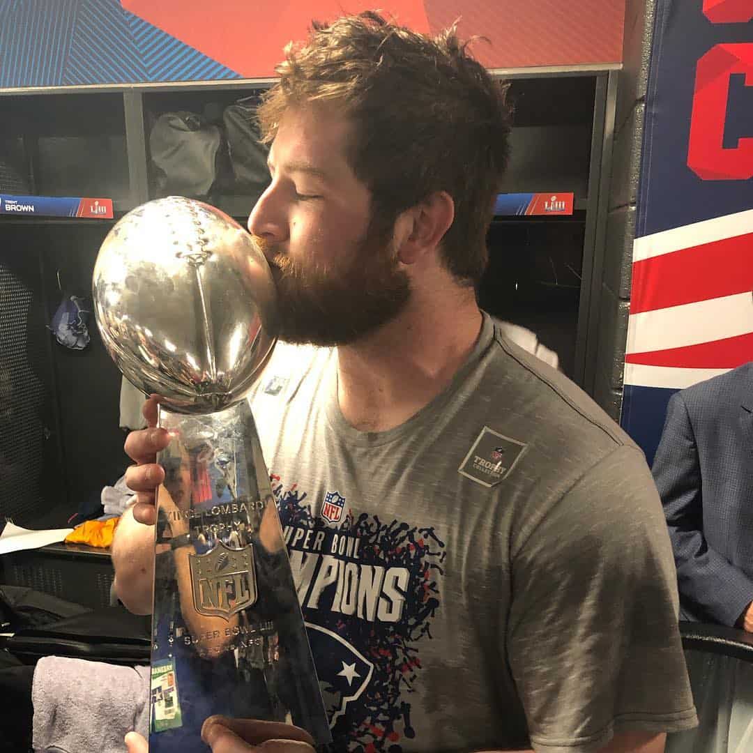 Joe Thuney Kissing his Super Bowl Trophy
