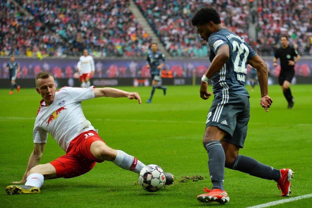 Lukas Klostermann tackling Serge Gnabry