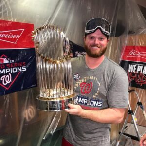 Aaron Barrett posing with World Series Trophy