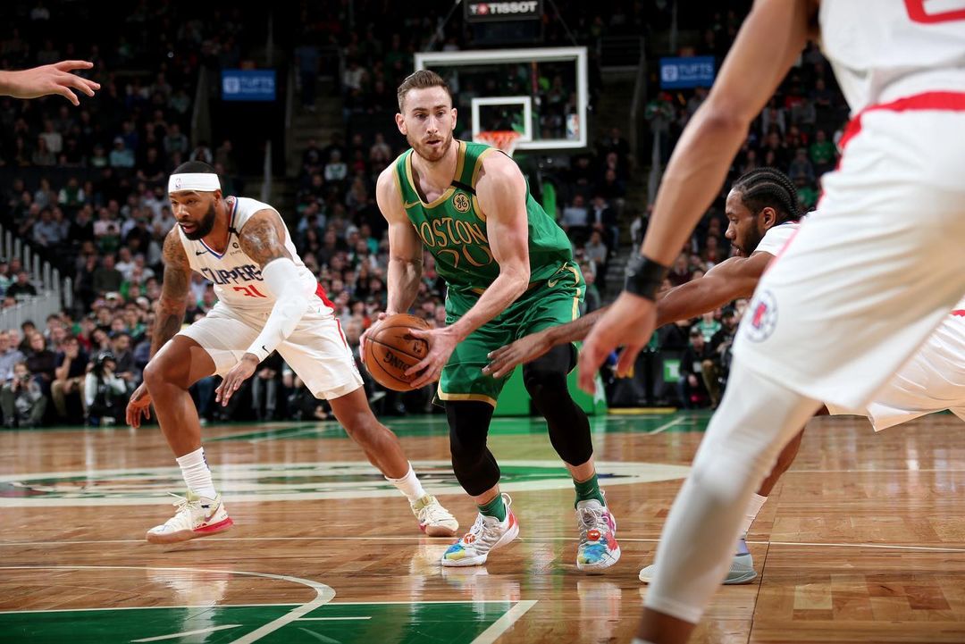 Gordon Hayward tries to dribble past Clippers players