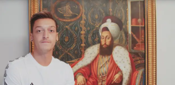 Mesut just standing besides the painting of Ottoman Sultan