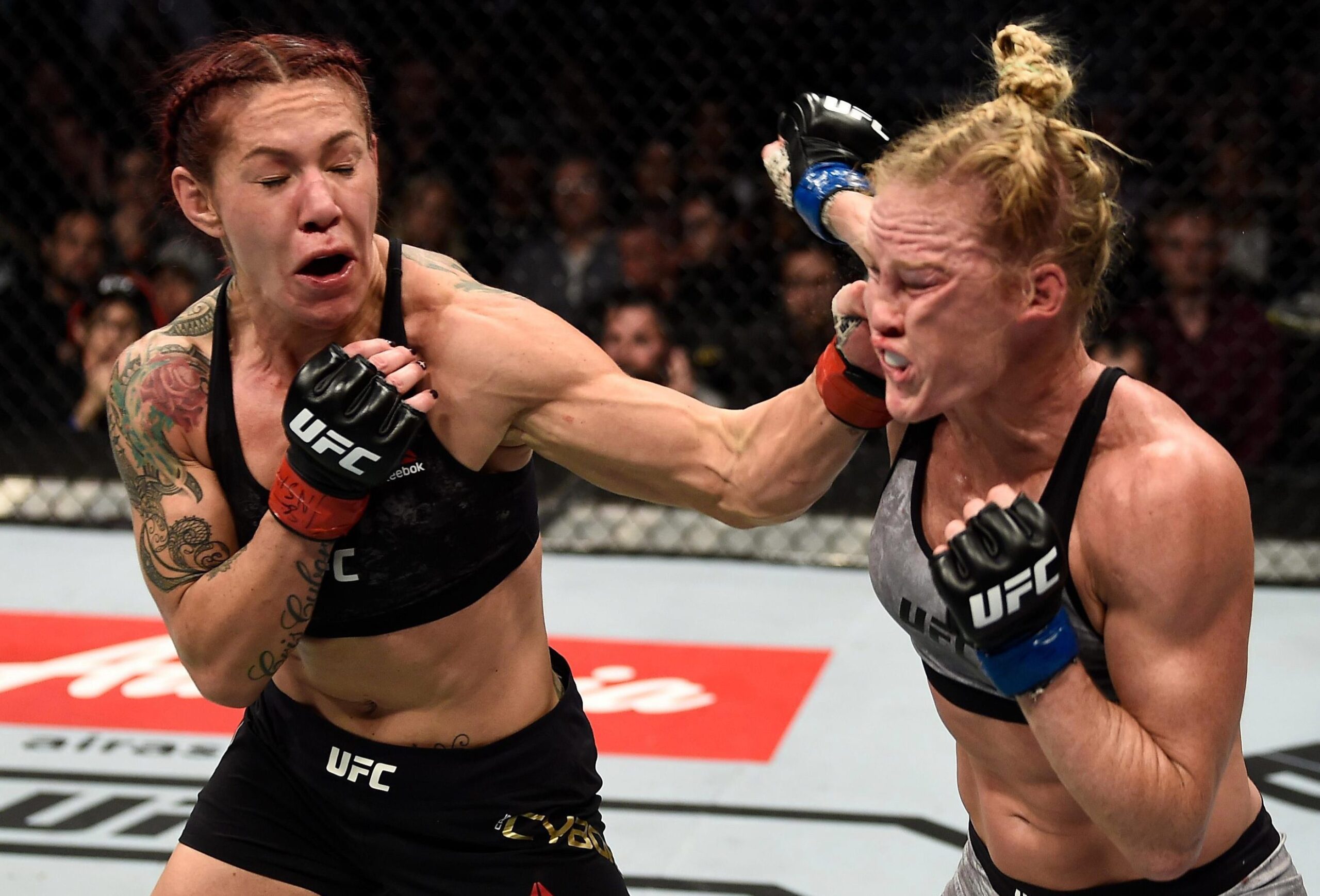 Cris Cyborg strong left hand punch over Holly Holm at UFC 219