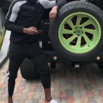 Usain-bolt-posing-with-his-car