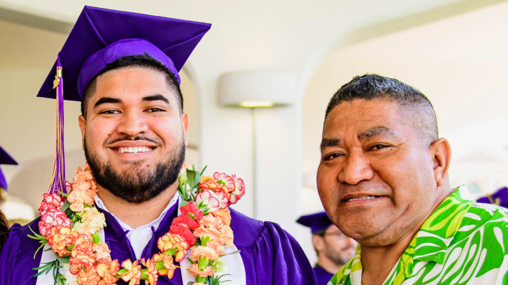 Breiden Fehoko with his role model father in the LSU graduation ceremony.