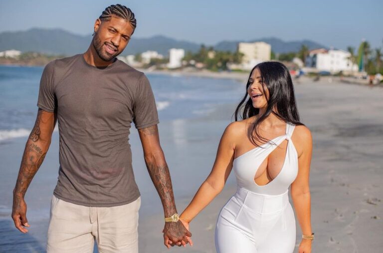 Paul George and Daniela holding hands by the beach
