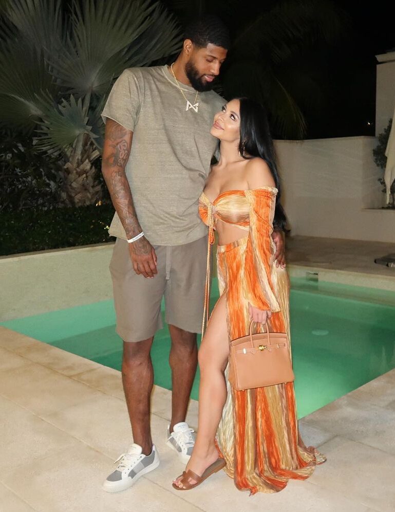 Paul George and his wife Daniela by the pool