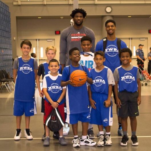 Joel Embiid with young fans. ( Source: wwba.com)