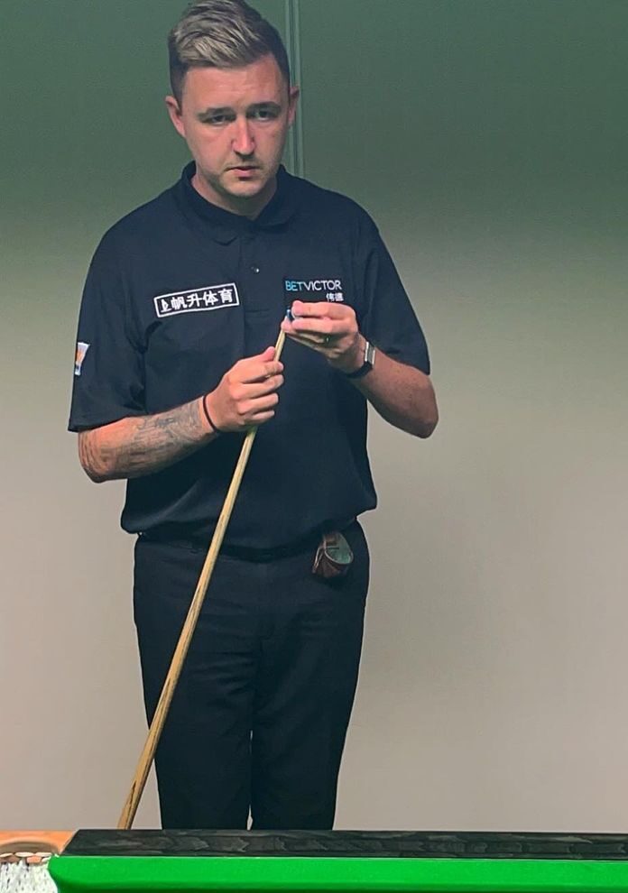 Kyren Wilson chalking his stick, thinking about the next best possible strike