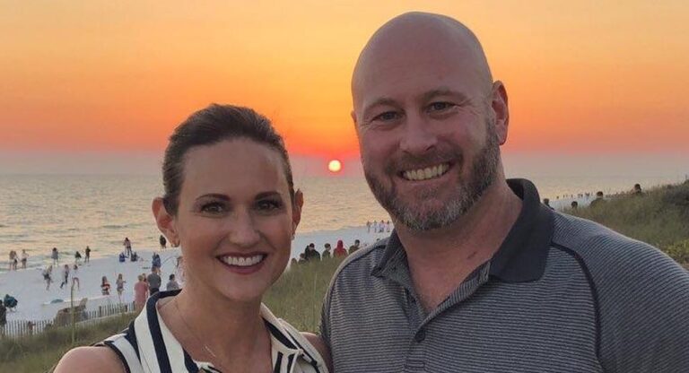 Cassandra and Trent Dilfer posing by a beautiful sunset