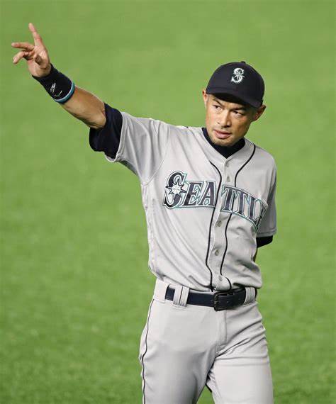 Yumiko Suzuki, right, wife of Seattle Mariners' Ichiro Suzuki and an  unidentified person, left, smile and cheer as they look on following  Ichiro's 200th hit in the second baseball game of a