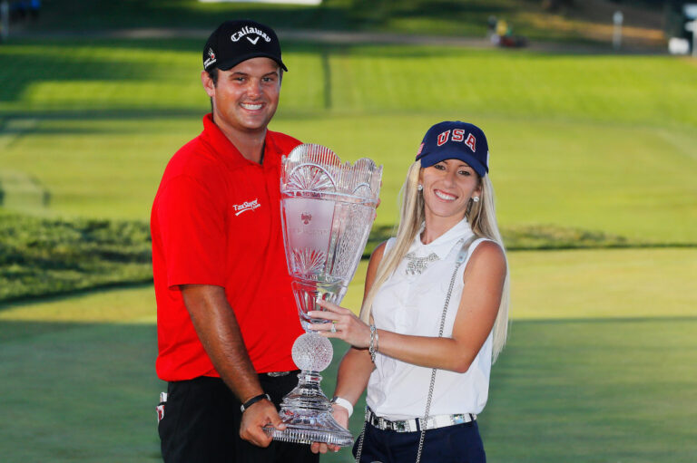 Patrick Reed along with his wife Justine Karain holding the trophy (Source: Sportscasting)