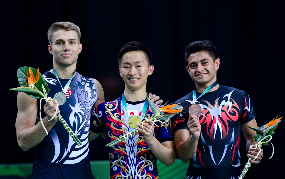 Mizuki Saito (middle) won gold at the 2018 Aerobic Gymnast World Championship with Hungary's Daniel Bali (left) and Ivan Veloz of Mexico (right)