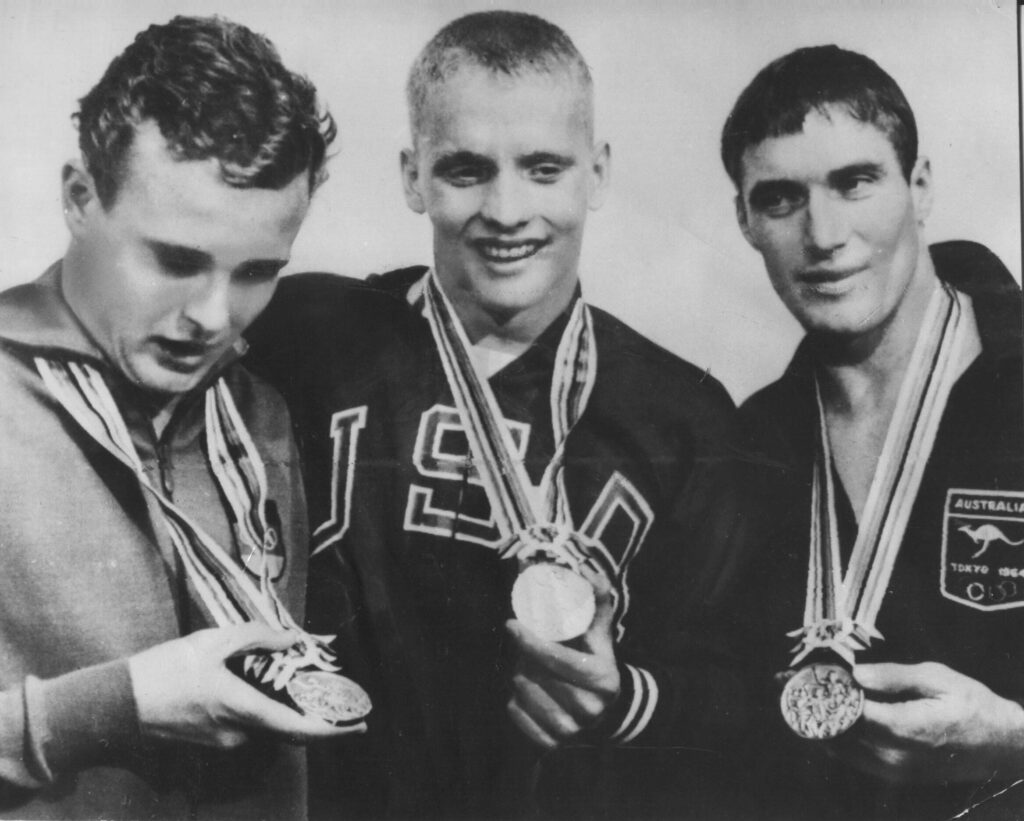Eighteen-year-old Don Schollander with a gold medal in the middle for 1964's Olympic men freestyle.