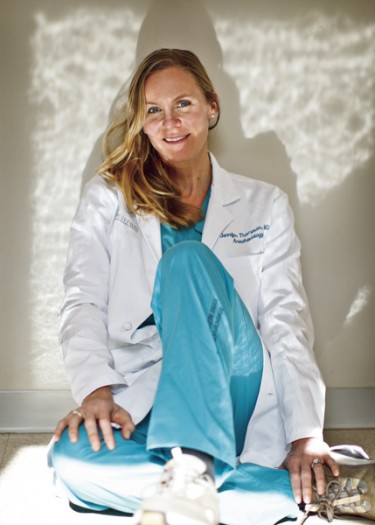 From the swimming pool to the operating room, Jenny Thompson posing wearing her white coat