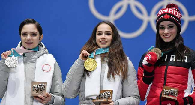 From left: Silver medalist , Evgenia Medvedeva, Gold medalist Alina Zagitova and Bronze medalist Kaetlyn Osmond in the 2018 Olympics
