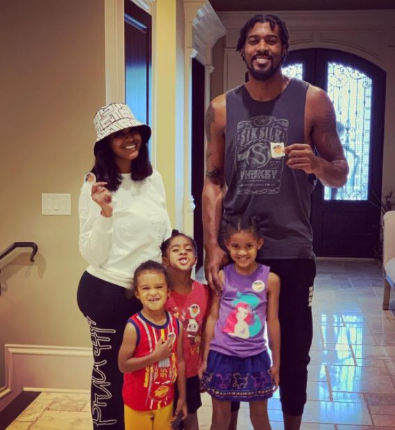 Derrick with his wife, twin daughters, and son
