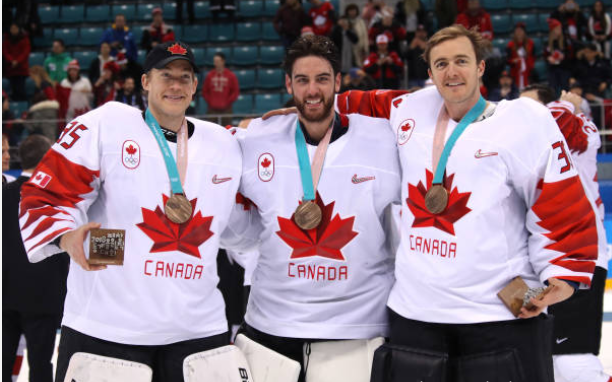 Justin Peters with his teammates after winning the bronze medal in the 2018 Olympics