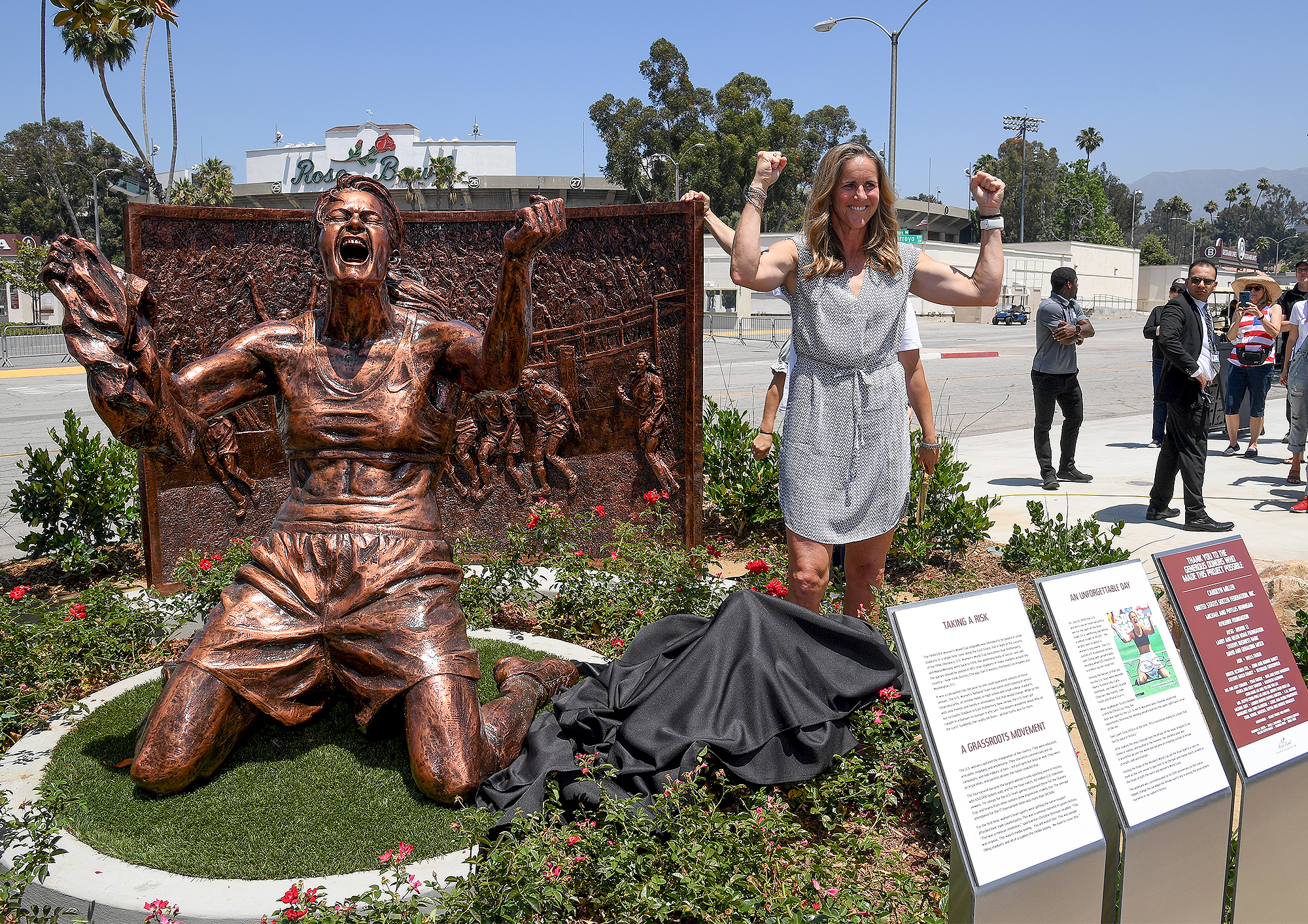 Brandi Chastian inront o her statue.