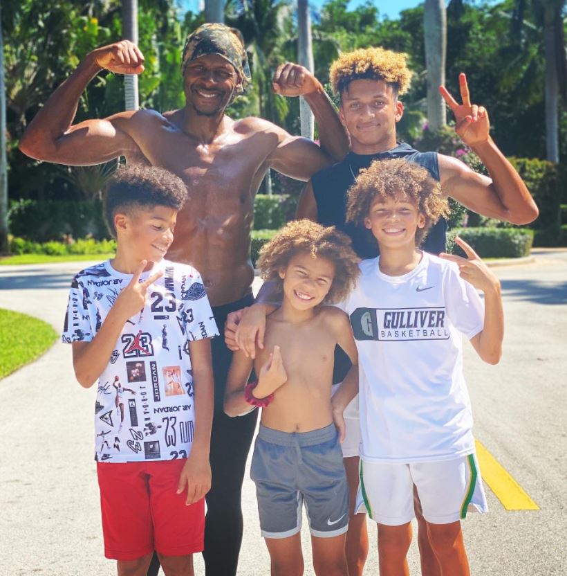 Ray Allen flexing his body with his kids