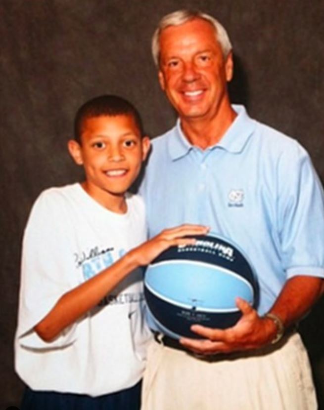 Young Justin Jackson with his coach, Roy Allen Williams