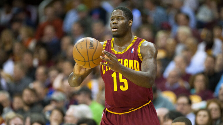 Anthony Bennett holding a ball wearing Cleveland Cavaliers Jersey