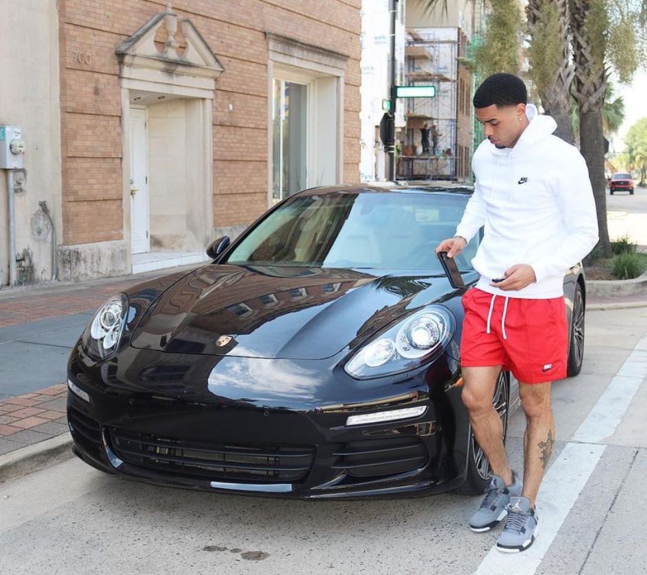 Josh Gray poses infront of his car