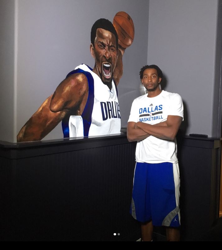 Jeremy Evans standing infront of the painting that he painted