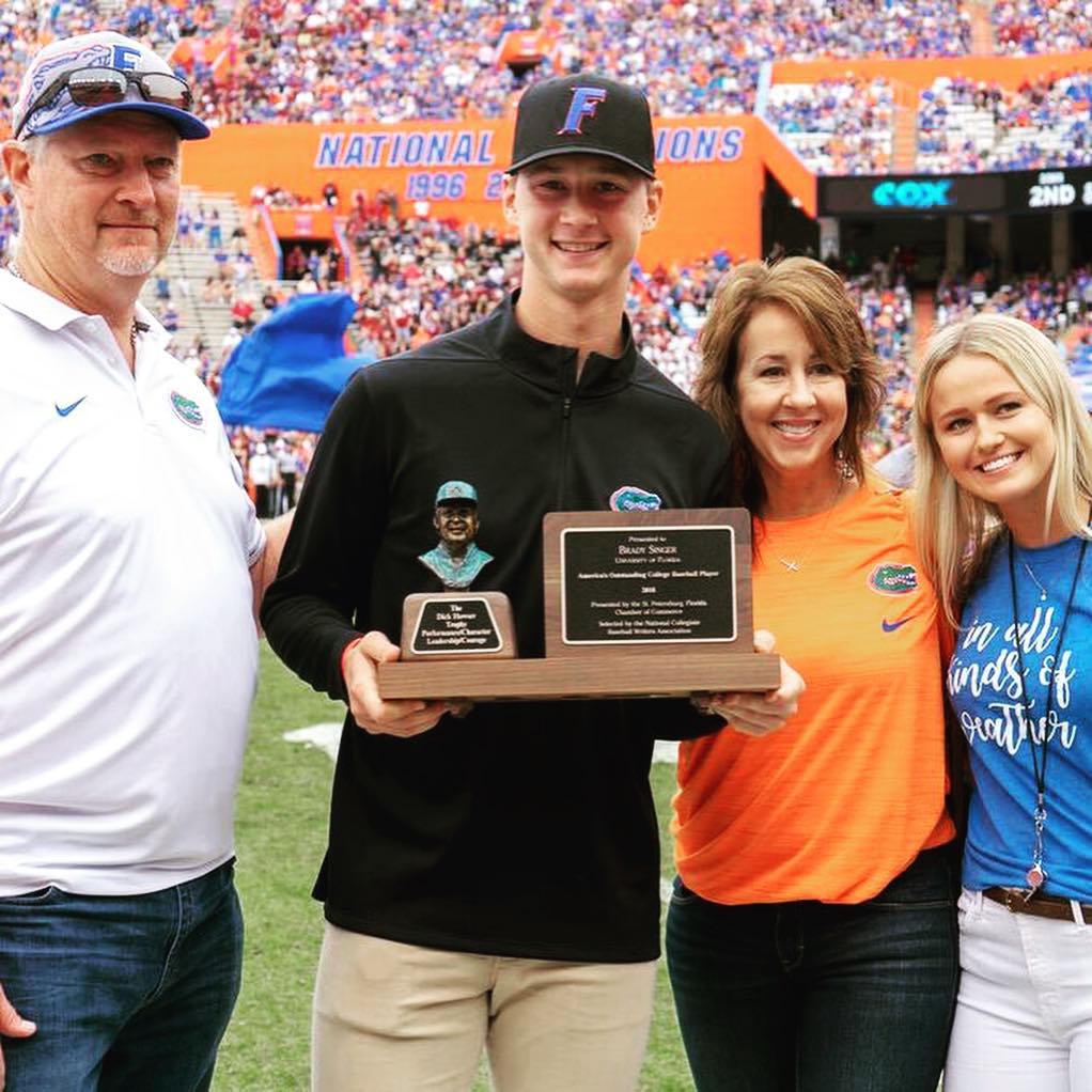 Brady Singer Holding Award With His Family