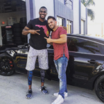 Brinson posing With Envy Motoring After They helped Him Into Upgrading His Ride