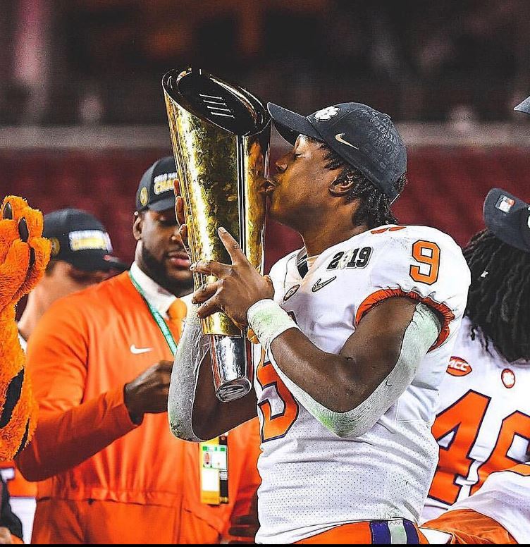 Travis Etienne Jr. With The 2018 CFP National Championship Trophy
