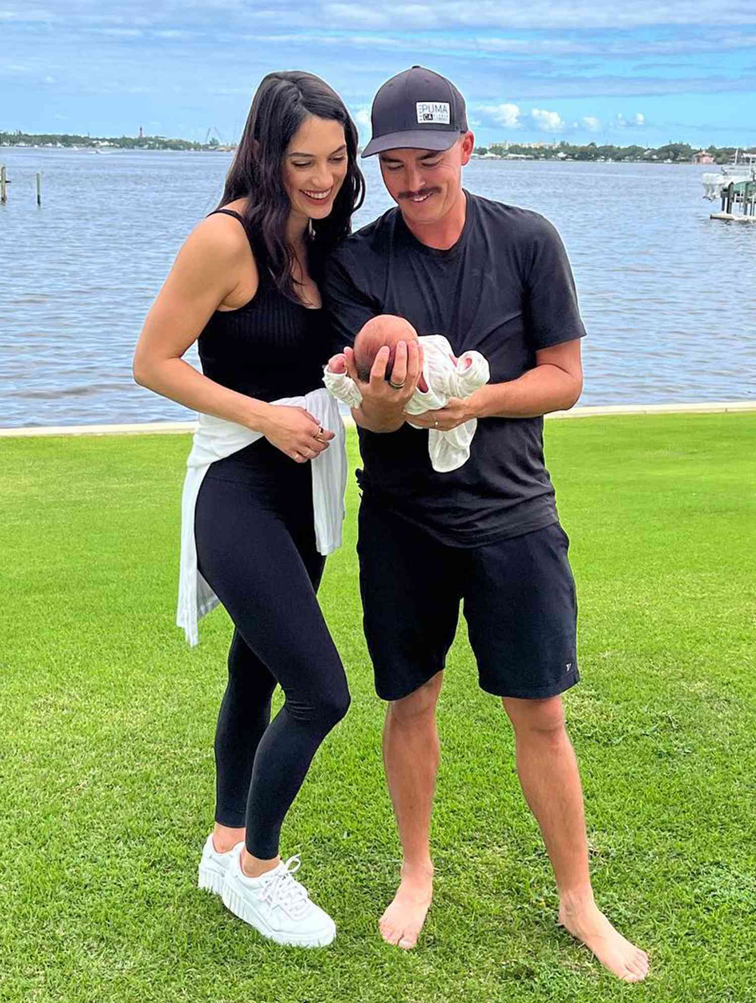 Rickie Fowler Holding HIs Kid And His Wife Allison Stokke 