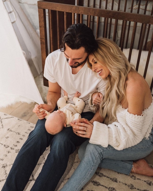 Connor Hellebuyck with his wife and child