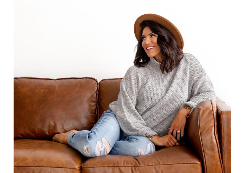 Amanda Latona sitting on the sofa