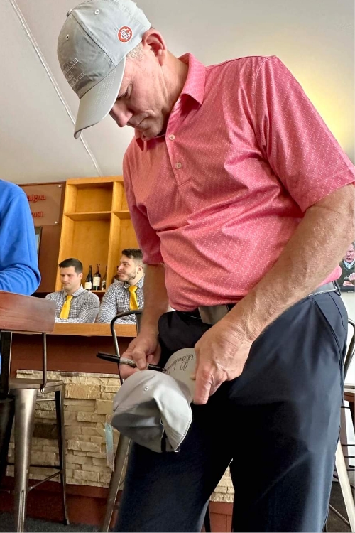 Shaun Micheel Signing A Fan's Cap