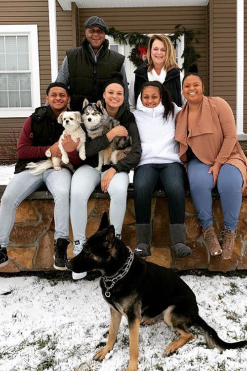 The McBride Family Posing For A Photo With Their Pets