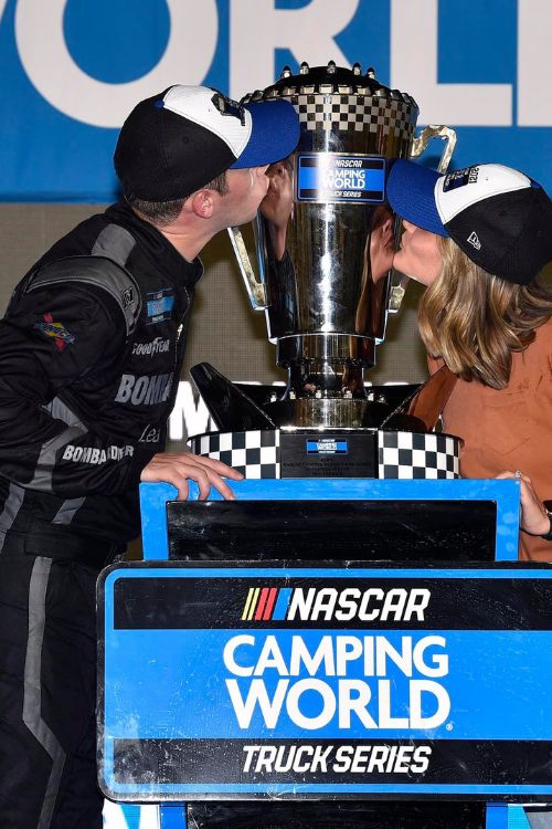 Ben And Caitlynn Rhodes Pictured Kissing The 2021 NASCAR Craftsman Truck Series Trophy 