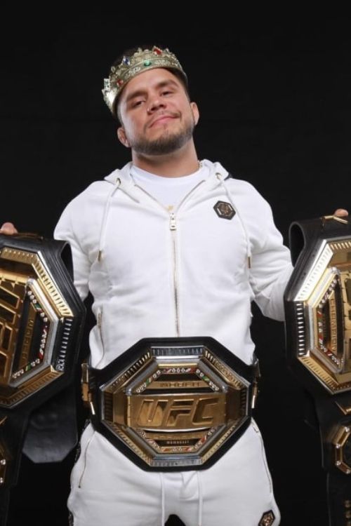Henry Cejudo With His Belts