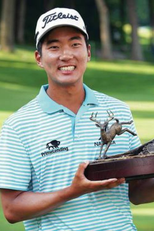 Michael Kim Smiles As He Poses With His John Deere Classic Trophy In 2018