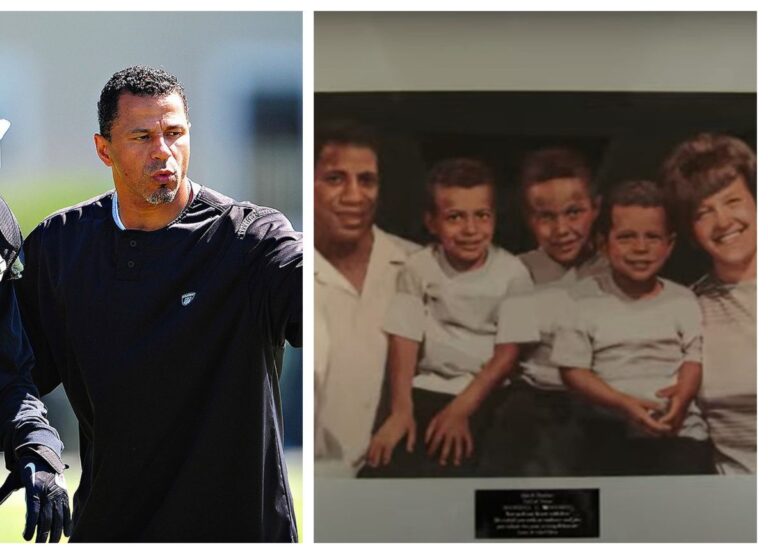 Football Coach Rod Woodson Shows The Family Portrait Of Him And His Parents And Brothers During An Interview