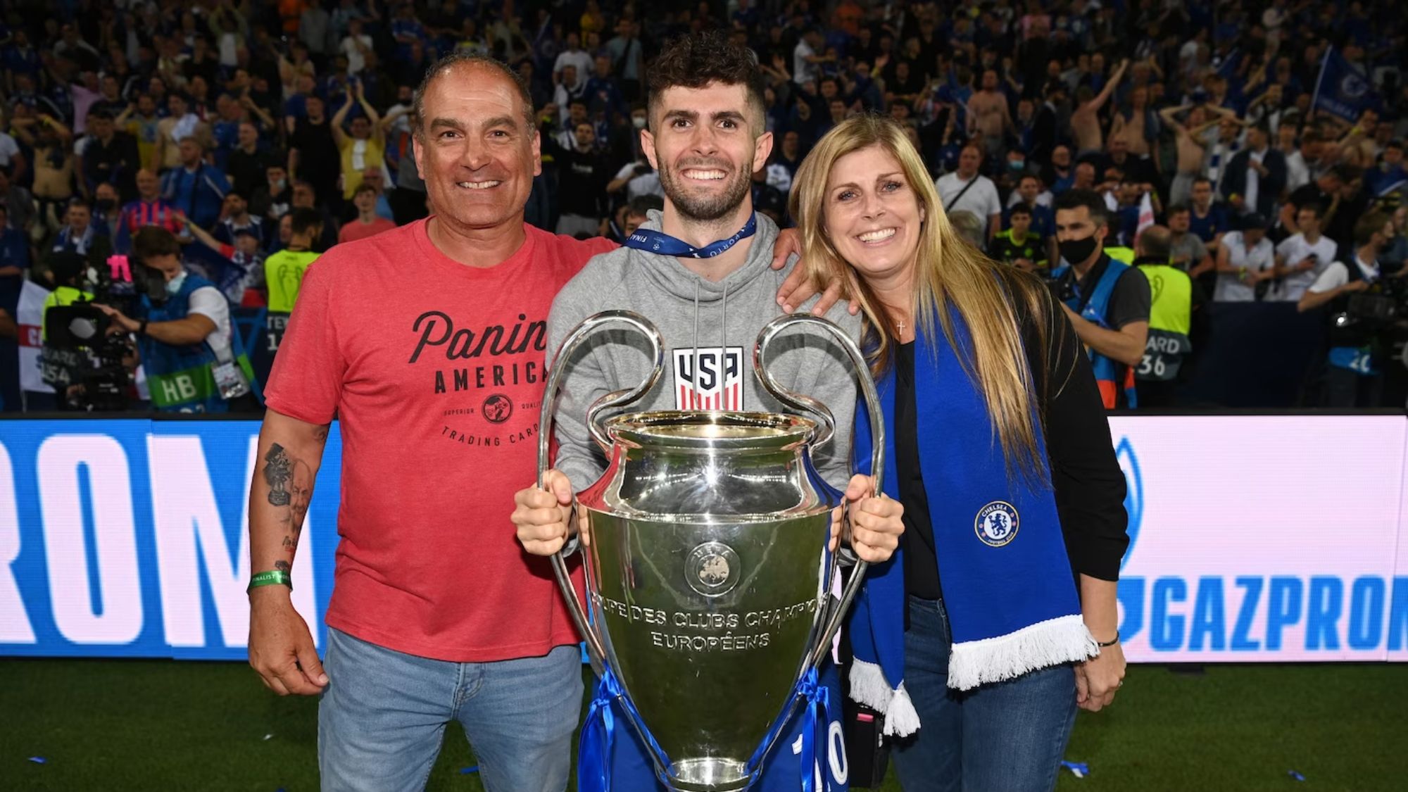 Christian Celebrating The UEFA Champions League Trophy With His Parents